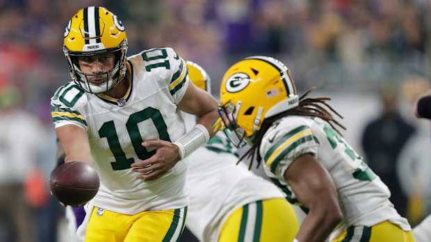 Dec 31, 2023; Minneapolis, Minnesota, USA; Green Bay Packers quarterback Jordan Love (10) hands off the ball to running back Aaron Jones (33) against the Minnesota Vikings during their game at U.S. Bank Stadium. Mandatory Credit: Dan Powers-USA TODAY Sports  